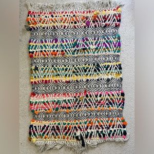 Brightly Covered Weaved Rug with Tassles